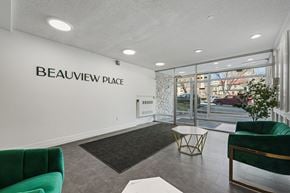 Calgary apartment for rent - A waiting area with a green couch and a sign that says Beauview Place.