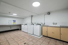 Calgary apartment for rent - A kitchen with white appliances and brown cabinets.