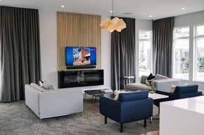 Surrey townhouse for rent - A modern living room with a fireplace and a television.