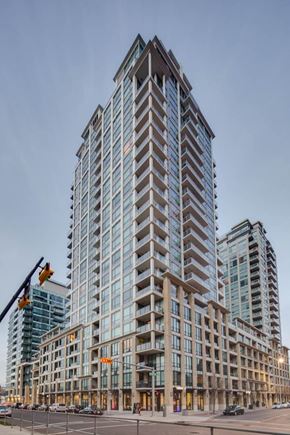 Calgary apartment for rent - A modern glass building stands tall in the cityscape.