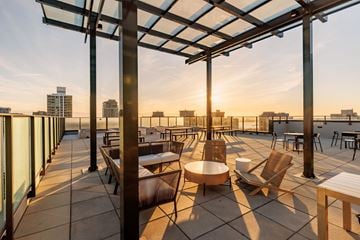North Vancouver apartment for rent - A patio with a table and chairs is set up on a rooftop.