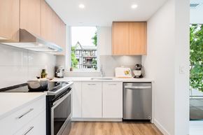 North Vancouver apartment for rent - A modern kitchen with white cabinets and a stainless steel dishwasher.