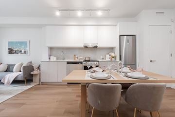 Coquitlam apartment for rent - A modern kitchen with a dining table set for two.