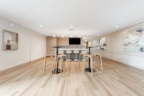 Coquitlam apartment for rent - A modern dining room with a wooden floor and a large painting on the wall.