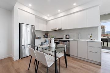 Coquitlam apartment for rent - A modern kitchen with a glass table and chairs.