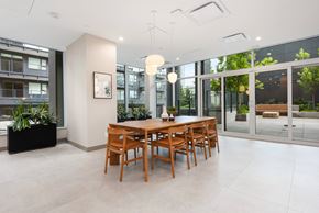 Coquitlam apartment for rent - A dining room with a wooden table and chairs.