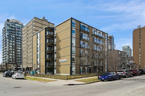 Calgary apartment for rent - A multi-story building with the sign