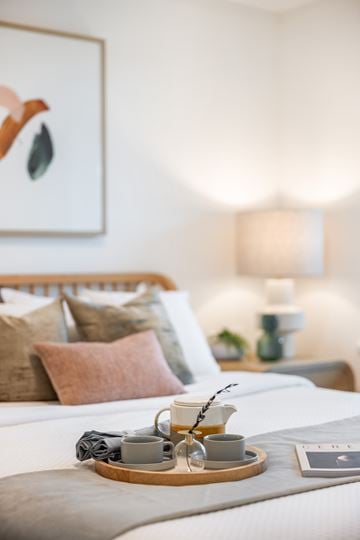 Surrey townhouse for rent - A tray with two cups of coffee and a folded napkin sits on a bed.