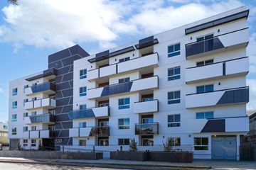 Los Angeles apartment for rent - A modern white apartment building with black and blue accents.