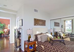 Los Angeles apartment for rent - A bedroom with a large bed and a wooden table.