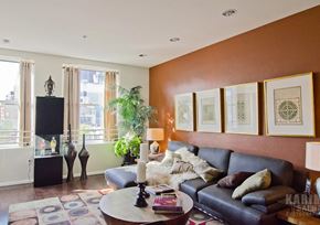 Los Angeles apartment for rent - A living room with a black leather couch, a coffee table, and a flat screen TV.
