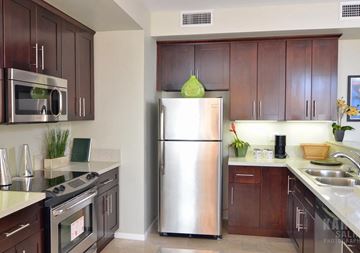 Los Angeles apartment for rent - A modern kitchen with a stainless steel refrigerator and wooden cabinets.