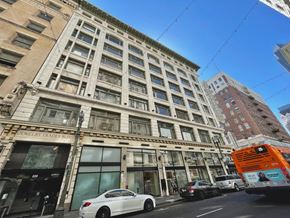 Los Angeles apartment for rent - A white car is parked in front of a building with a sign that says "Jewelry Trades Bldg.".