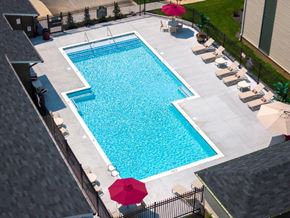 Louisville apartment for rent - a swimming pool in a backyard with umbrellas and chairs