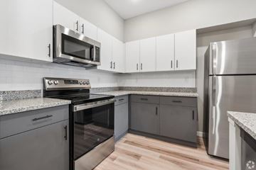 Louisville apartment for rent - A kitchen with a stainless steel refrigerator and microwave.