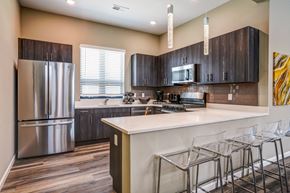 Louisville apartment for rent - A kitchen with a white counter top and a refrigerator.