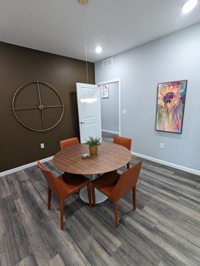 Louisville apartment for rent - a dining room with a wooden table and orange chairs