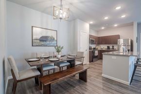 Louisville apartment for rent - A modern kitchen with a dining table set for four.