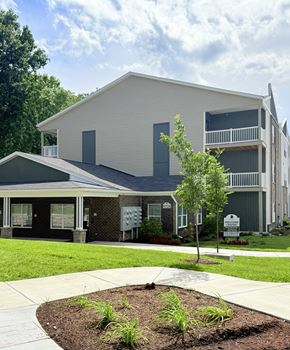 Louisville apartment for rent - A modern two-story building with a balcony on the upper floor.