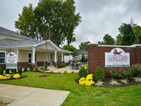 Louisville apartment for rent - the clubhouse at the willard with a sign in front of the building