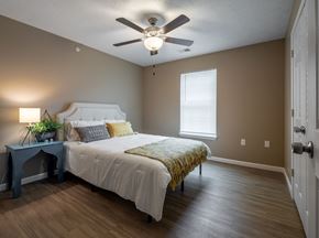 Sellersburg apartment for rent - a bedroom with a ceiling fan and a bed