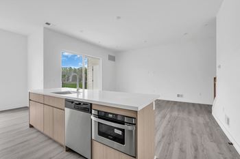 A kitchen with a large counter top and a window