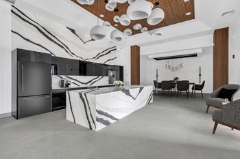 A kitchen with a marble island in the middle of it