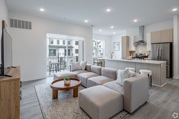 Marlboro apartment for rent - A modern living room with a grey sofa set and a wooden coffee table.