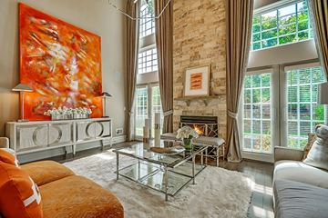 Mountainside apartment for rent - A living room with a fireplace and a large painting on the wall.