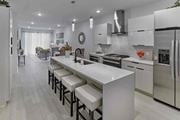 Franklin Lakes apartment for rent - a large white kitchen with an island with white chairs