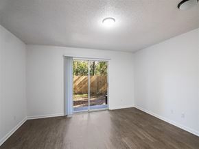 Pensacola apartment for rent - A room with a sliding glass door leading to a backyard. at The Palmiere Apartments, Pensacola, 32526