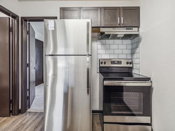 Pensacola apartment for rent - a kitchen with stainless steel appliances and a refrigerator at The Papillon, Florida, 32504