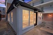 Metairie apartment for rent - the front of a white building with glass windows at The Maxwell Apartments, Louisiana