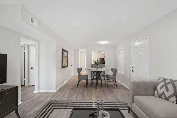 Metairie apartment for rent - a living room and dining room with white walls and wood floors at The Maxwell Apartments, Louisiana, 70002