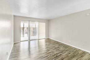 Fort Worth apartment for rent - A room with wooden flooring and a sliding glass door.