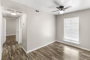 Fort Worth apartment for rent - A room with a ceiling fan and a window with blinds.