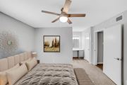 Metairie apartment for rent - A bedroom with a large bed and a ceiling fan.