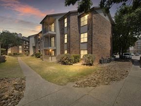 Dallas apartment for rent - an apartment building with the lights on at dusk