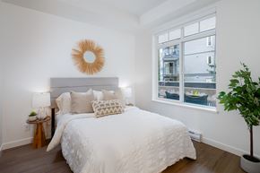 Langley apartment for rent - A bedroom with a large bed and a window overlooking a balcony.