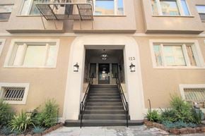 Oakland apartment for rent - the front of a building with stairs and a door