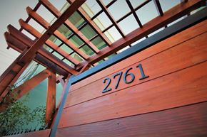 Concord apartment for rent - a close up of a wooden gate with a house number on it
