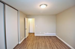 Oakland apartment for rent - a living room with wood flooring and a door to a closet
