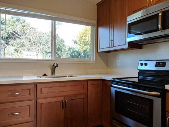 San Leandro apartment for rent - a kitchen with a stove and a sink and a window