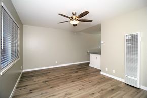 San Leandro apartment for rent - an empty living room with wood floors and a ceiling fan