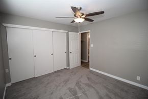 San Leandro apartment for rent - a bedroom with a ceiling fan and white closets