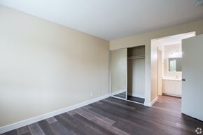 El Sobrante apartment for rent - an empty living room with hard wood flooring and a glass door to a bathroom