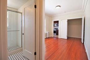 Oakland apartment for rent - a renovated living room with a glass closet and a wood floor