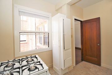Oakland apartment for rent - a kitchen with a stove and a door to a closet