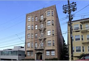 Oakland apartment for rent - a tall apartment building with a fire escape