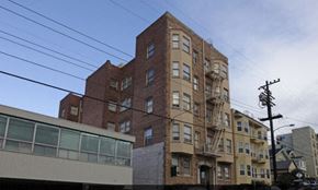 Oakland apartment for rent - a tall brick building with a fire escape